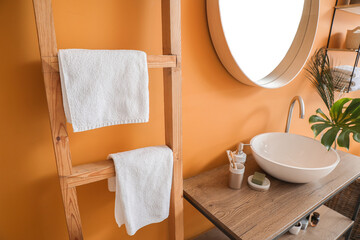 Stylish interior of modern bathroom with clean towels