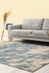 Interior of modern room with sofa and beautiful carpet