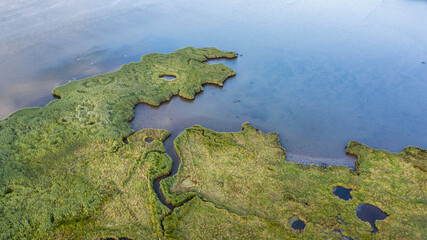 Drone bird's eye view landscape image of tidal wetlands in Christchurch Harbour on England's South Coast - obrazy, fototapety, plakaty