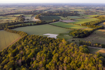 Beautiful drone landscape image over lush green Summer English countryside during late afternoon light