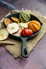 Beautiful food portrait of Wnter seasonal dried fruits with old vintage texture background and cutlery and accessories