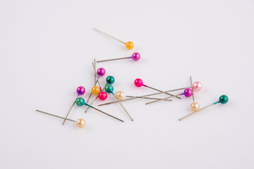 colorful ball point pins in white background