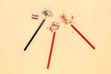 Pencils and shavings on color background