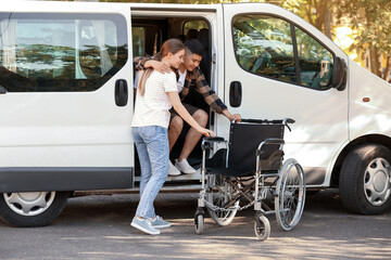 Fototapeta na wymiar Woman helping her handicapped husband to get out of van