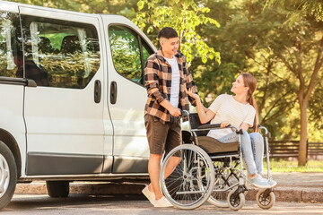 Handicapped woman and her husband near van outdoors