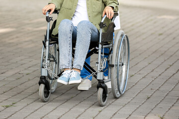 Doctor and young woman in wheelchair outdoors