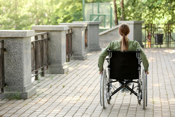 Young woman in wheelchair outdoors