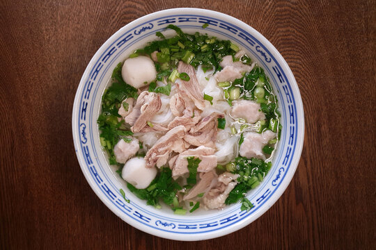 Top View A Bowl Of Flat Rice Noodles Served In A Clear Duck Meat Soup Broth And Fish Ball. Penang Famous Hawker Food