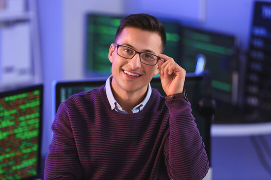 Portrait of male programmer in office at night