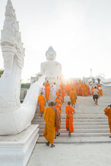 Young buddhists in orange clothes near the Big Buddha Temple in Phuket in Thailand. April 28, 2019.