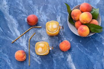 Mason jars of tasty peach juice on color background
