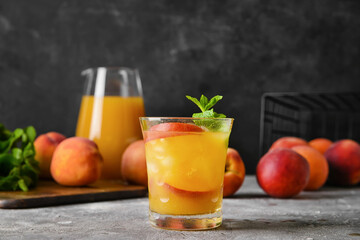 Glass of tasty peach juice on table