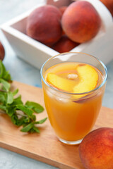 Glass of tasty peach juice on table