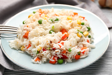 Plate with tasty pilaf on table, closeup