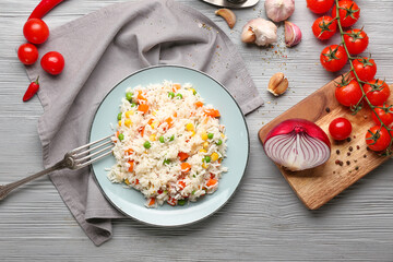 Plate with tasty pilaf on table