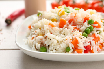 Plate with tasty pilaf on table, closeup