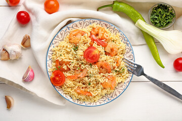 Plate with tasty pilaf on table