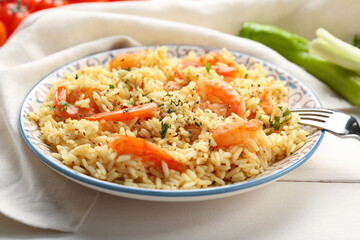 Plate with tasty pilaf on table