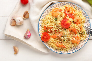 Plate with tasty pilaf on table