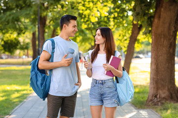 Young couple with bottles of water in park