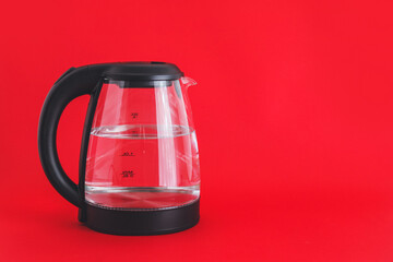 Electric kettle on color background