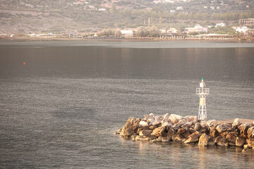 Sunrise. Early morning. Harbour with marine vessels, boats and lighthouse. 