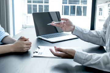 Business people hold a resume and talk to job applicants for job interviews about careers and Her personal history in the company. Recruitment concepts