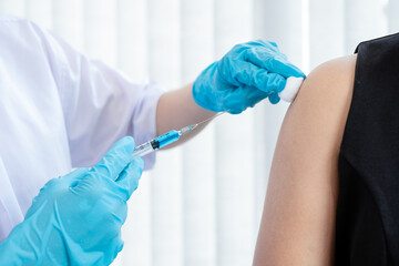 Male doctors vaccinated with syringes to prevent epidemics at hospitals, health care, and medical...