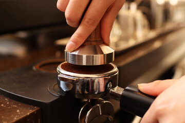 close up of a hand holding a coffee maker