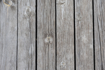 Old grey barn wood background texture with scratches and cracks close up