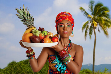 Portrait of a sweet Black Woman with a tray of fruit against the background of nature