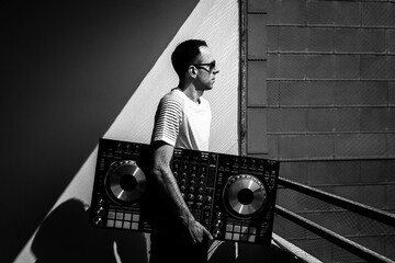 Black and white photo of man with Dj console