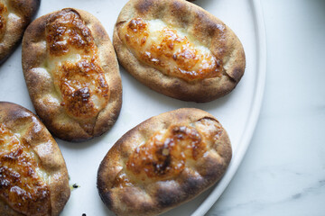 Traditional Finnish Karelian pasties on white marble background
