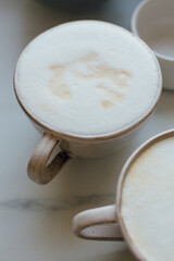 Top view of coffe Cappuccino cup on white marble background with copy space