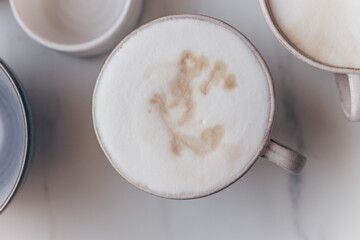 Top view of coffe Cappuccino cup on white marble background with copy space