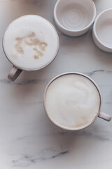 Top view of coffe Cappuccino cup on white marble background with copy space
