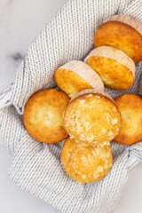 Freshly baked tasty vanilla muffins and muffins with crumble topping. Light grey background.