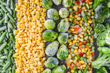 Different frozen vegetables as background, top view. Stocking up vegetables for winter storage. Assortment of frozen vegetables