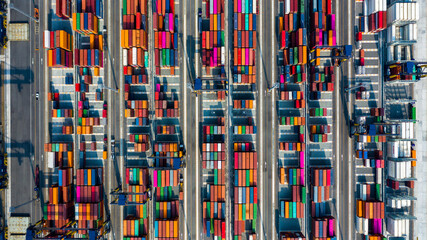 Aerial view of area with stacked containers at the port, Top view stack of freight containers in rows at the shipyard, Global business cargo logistics shipping industry export import transportation.