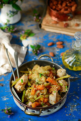 Chicken breast with vegetables and almond.