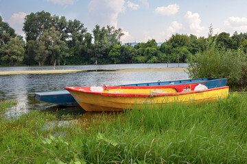 Old wooden fishing boats on a pond. Traditional small fishing boats on river bank in northern part of Serbia.
