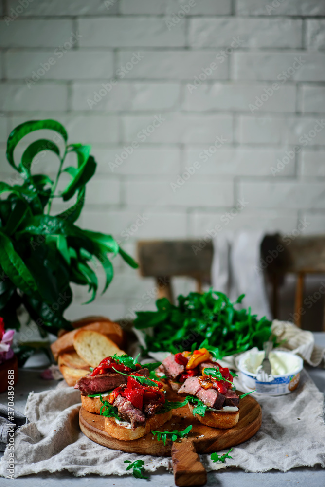 Wall mural Crostini with steak  with roasted bell pepper. style rustic