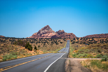 Empty scenic highway in Arizona, USA. Natural american landscape with asphalt road to horizon. Desert highway at sunset, travel concept, USA.