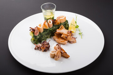 Fried seafood snacks with potato garnish