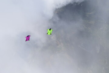 Skydivers over snowy mountains in Norway