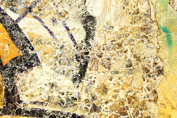 Abstract creative background of chaotic strokes of old cracked paint on concrete wall. Old surface with traces of paint, weathered, scratches and cracks for design