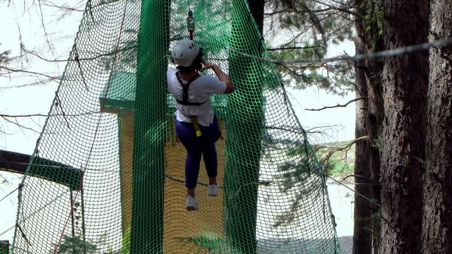 Teenager having fun on a zip line in Bansko, Bulgaria