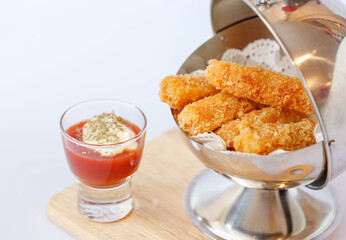 chicken nuggets with sauces on wooden board
