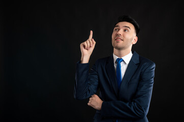 Portrait of business man wearing blue business suit and tie he thinks of an idea