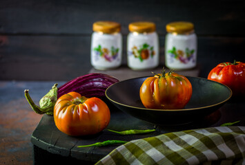 Preparation with vegetables on dark ground in the kitchen